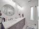 Elegant bathroom with dual vanities, round mirrors, and a glass-enclosed shower at 901 Burnley Rd, Charlotte, NC 28210