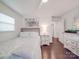 Bright bedroom features a comfortable bed, stylish furnishings, and hardwood floors at 901 Burnley Rd, Charlotte, NC 28210