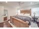Spacious bedroom with a large wooden bed, stylish rug, and ample natural light at 901 Burnley Rd, Charlotte, NC 28210