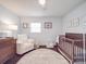 Cozy Bedroom features a rocking chair, crib, and a dresser with decor and natural light at 901 Burnley Rd, Charlotte, NC 28210