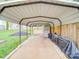 Covered carport providing protection for vehicles and additional outdoor storage space at 901 Burnley Rd, Charlotte, NC 28210