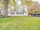 Charming home with a beautifully landscaped front yard, mature trees, and a lovely garden at 901 Burnley Rd, Charlotte, NC 28210