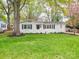 Charming, freshly painted white brick home with black shutters and lush green lawn at 901 Burnley Rd, Charlotte, NC 28210