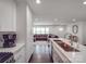 White kitchen features sleek countertops, stainless steel appliances, and an open layout into the living area at 901 Burnley Rd, Charlotte, NC 28210