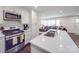 Bright, modern kitchen boasts stainless steel appliances, white cabinetry, and a spacious island with seating at 901 Burnley Rd, Charlotte, NC 28210