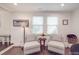 Relaxing living room with neutral-toned chairs, a small table and bright natural light at 901 Burnley Rd, Charlotte, NC 28210