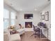 Cozy living room with a brick fireplace and an adjacent workspace area at 901 Burnley Rd, Charlotte, NC 28210
