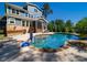 Stunning backyard with a gunite pool, outdoor cooking area, and mature trees surrounding the property at 101 Cross Current Ln # 137, Belmont, NC 28012