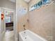 Bright bathroom showcasing tile, a shower head with a bathtub and a view through the window at 101 Cross Current Ln # 137, Belmont, NC 28012