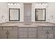 Bathroom featuring double sinks, granite counters, gray cabinets, and large mirrors at 101 Cross Current Ln # 137, Belmont, NC 28012
