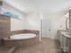 Bathroom featuring a soaking tub, tiled shower, granite counters, and tile floors at 101 Cross Current Ln # 137, Belmont, NC 28012