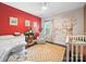 Bedroom with a red accent wall, hardwood floors, and a charming Winnie the Pooh mural at 101 Cross Current Ln # 137, Belmont, NC 28012