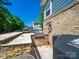 Outdoor kitchen and grill area with stone accents, perfect for entertaining guests by the pool at 101 Cross Current Ln # 137, Belmont, NC 28012