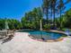 Inviting backyard pool featuring a stone surround, lush landscaping, and ample space for outdoor seating at 101 Cross Current Ln # 137, Belmont, NC 28012