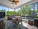 Relaxing screened porch with comfortable seating and ceiling fan, offering views of the lush backyard and pool at 101 Cross Current Ln # 137, Belmont, NC 28012