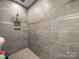 Walk-in shower with gray tile, glass accents, and a built-in niche at 101 Cross Current Ln # 137, Belmont, NC 28012