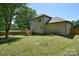 Spacious backyard with a wooden deck, mature trees, and a privacy fence, ideal for outdoor living at 1021 Vickie Ln, Matthews, NC 28104