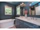 Elegant bathroom with a soaking tub, double vanity, and stylish fixtures at 1021 Vickie Ln, Matthews, NC 28104