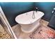 A pristine soaking tub is paired with stylish fixtures and a patterned rug at 1021 Vickie Ln, Matthews, NC 28104