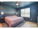 Comfortable bedroom with a king-size bed, ceiling fan, and large window at 1021 Vickie Ln, Matthews, NC 28104