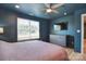 Cozy bedroom features a plush bed, window view, ceiling fan, and mounted TV at 1021 Vickie Ln, Matthews, NC 28104