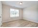 Bright bedroom with a large window and light-colored wood floors, offering a serene and inviting space at 1021 Vickie Ln, Matthews, NC 28104