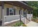 Inviting front porch adorned with hanging flower baskets, providing a charming and welcoming entrance at 1021 Vickie Ln, Matthews, NC 28104