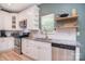 White cabinets and stainless appliances brighten this modern kitchen at 1021 Vickie Ln, Matthews, NC 28104
