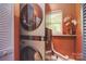 This laundry area features a stacked washer/dryer set and a quaint window for natural light at 1021 Vickie Ln, Matthews, NC 28104