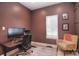 Stylish home office featuring grid wall design, modern desk setup, and comfortable seating at 1021 Vickie Ln, Matthews, NC 28104