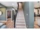 Inviting staircase with wooden steps, black iron railing, and an abundance of natural light at 1021 Vickie Ln, Matthews, NC 28104