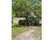 Tan single-story home featuring a small porch and mature trees at 104 Poplar St, Clover, SC 29710