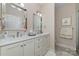 Well-lit bathroom featuring double sinks and white cabinets and counters at 106 Independence Ct, Kings Mountain, NC 28086