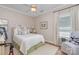 Charming bedroom featuring a cozy bed with floral accents and a bright window at 106 Independence Ct, Kings Mountain, NC 28086