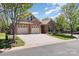 Charming brick home featuring a two-car garage and a well-manicured lawn on a tree-lined street at 106 Independence Ct, Kings Mountain, NC 28086