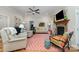Cozy living room with a stone fireplace, ceiling fan, hardwood floors, and comfortable seating at 106 Independence Ct, Kings Mountain, NC 28086