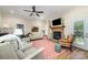 Comfortable living room featuring a stone fireplace, ceiling fan, hardwood floors, and neutral walls at 106 Independence Ct, Kings Mountain, NC 28086
