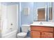 Well-lit bathroom with a bathtub/shower combination, toilet, and vanity at 11447 Potters Row, Cornelius, NC 28031