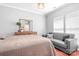Inviting bedroom boasts a dresser with a mirror, a comfortable sofa, and plenty of natural light at 11447 Potters Row, Cornelius, NC 28031