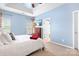 Spacious bedroom with a tray ceiling, two windows, and a chest of drawers at 11447 Potters Row, Cornelius, NC 28031