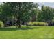 Lawn area, trees, shrubs and seating provide for a relaxing community green space at 11447 Potters Row, Cornelius, NC 28031