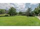 Trees and shrubs highlight a community lawn area with single bench at 11447 Potters Row, Cornelius, NC 28031