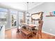 Bright dining area with wood table and a door that leads to the outdoors at 11447 Potters Row, Cornelius, NC 28031