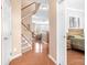 Inviting foyer features gleaming hardwood floors, elegant staircase, and access to bedroom at 11447 Potters Row, Cornelius, NC 28031