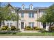 Charming townhome boasts beautiful brick facade, manicured landscaping, and inviting entrance at 11447 Potters Row, Cornelius, NC 28031