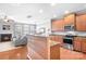 Open-concept kitchen with stainless steel appliances, granite countertops, and hardwood floors at 11447 Potters Row, Cornelius, NC 28031