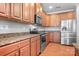Well-equipped kitchen features wood cabinets, stainless steel appliances, and granite countertops at 11447 Potters Row, Cornelius, NC 28031