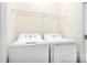 Bright laundry room showcasing a neatly arranged washer and dryer set at 11447 Potters Row, Cornelius, NC 28031