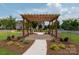 Pergola with seating, landscaping, and views of the neighborhood homes at 11447 Potters Row, Cornelius, NC 28031