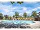 A large community swimming pool surrounded by lush greenery and comfortable lounge chairs at 11447 Potters Row, Cornelius, NC 28031